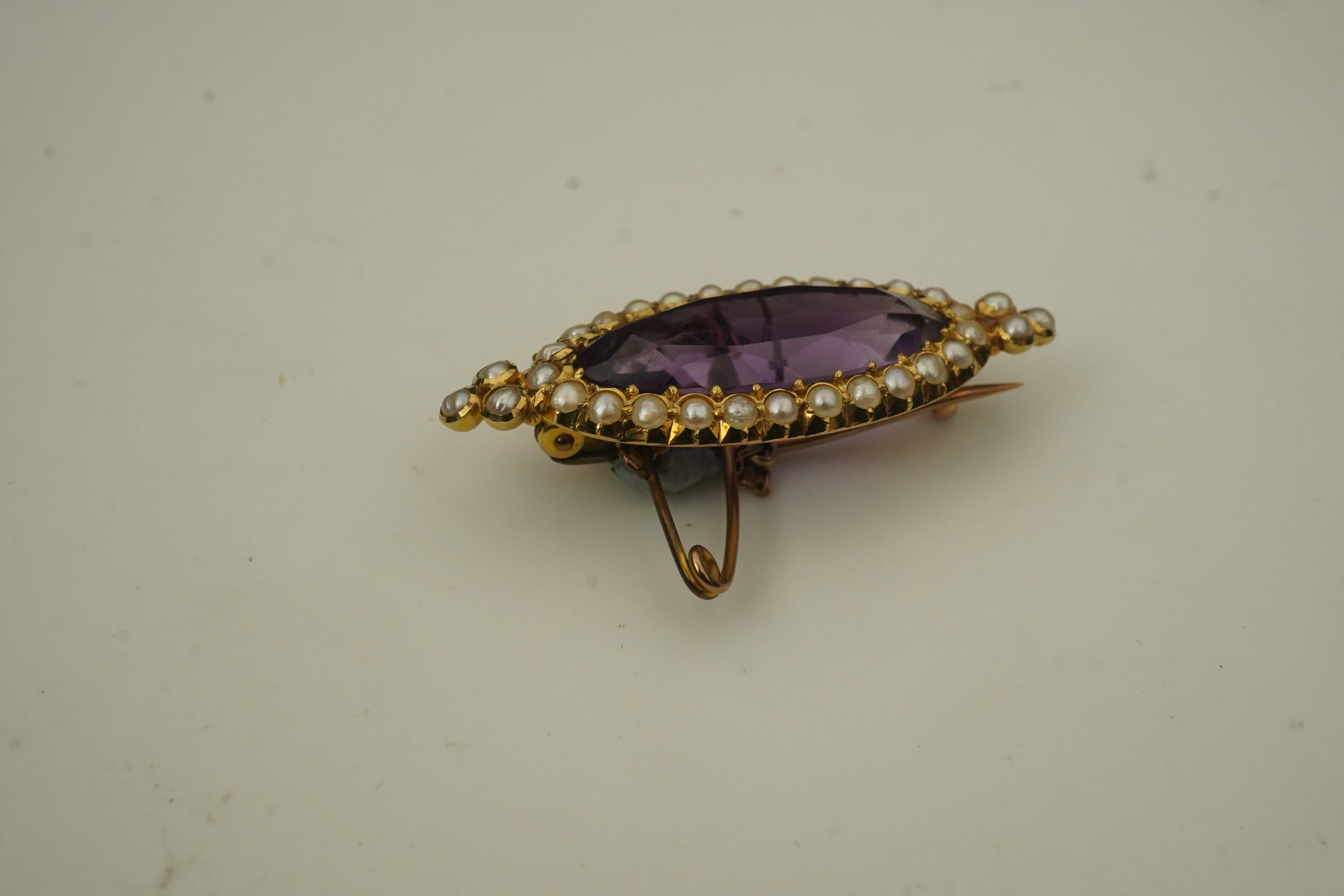 An amethyst and pearl brooch, circa 1900